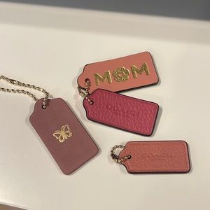 Coach bag tags/key chains. New. One stamped with MOM